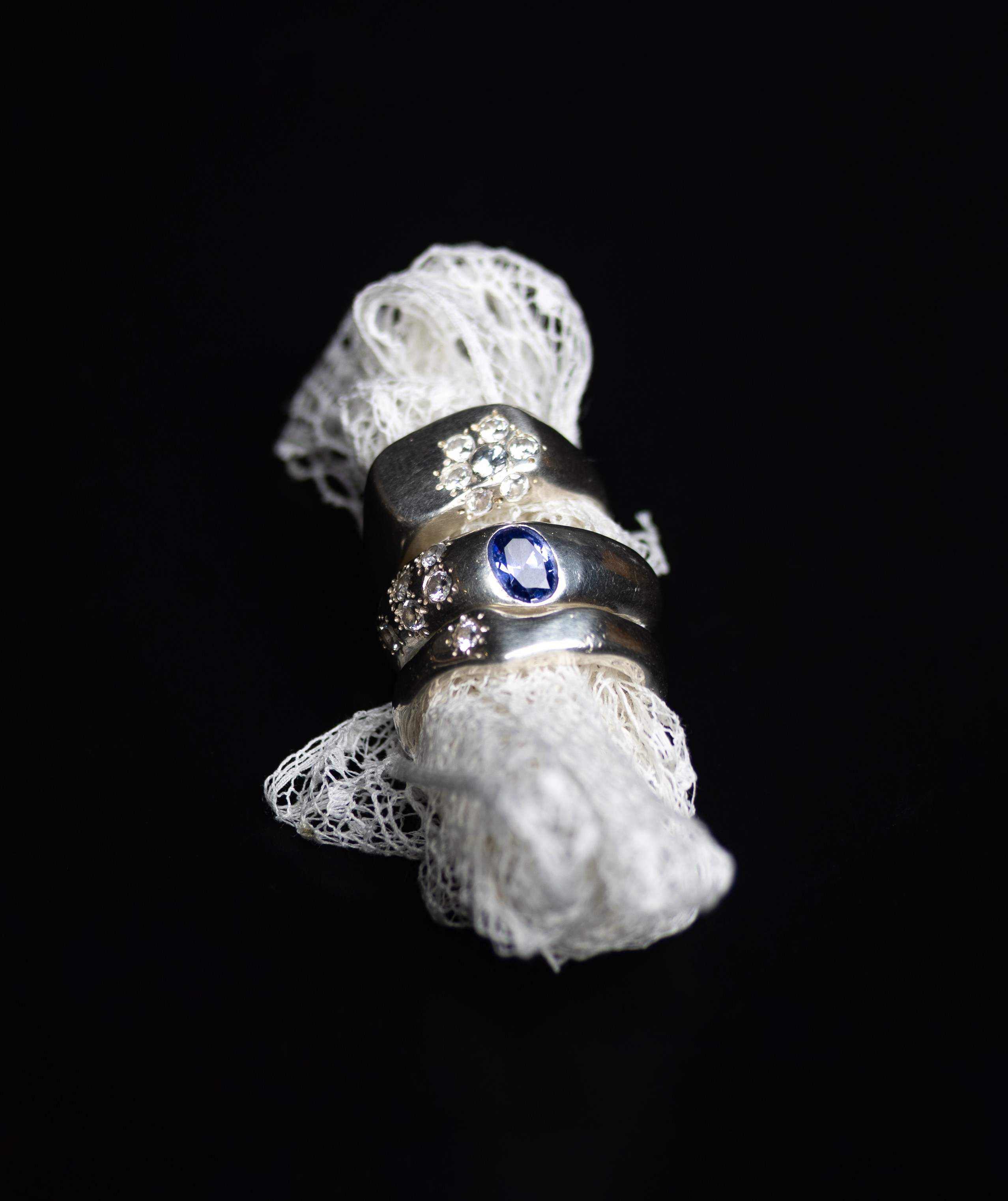 Hand-hammered sterling silver solitaire ring on black background
